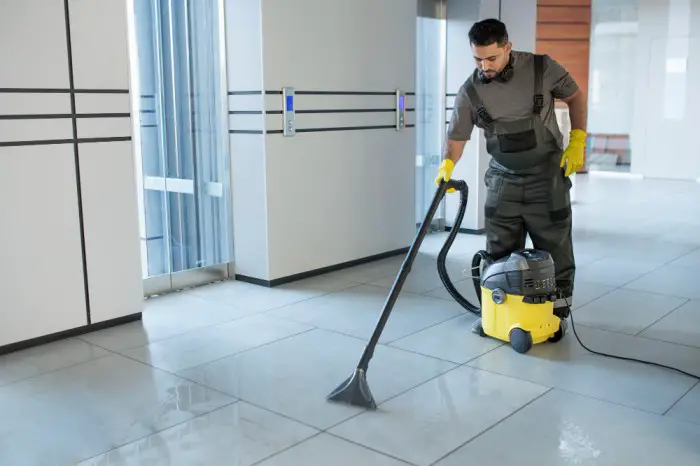 full-shot-man-vacuuming-office-floor (1)